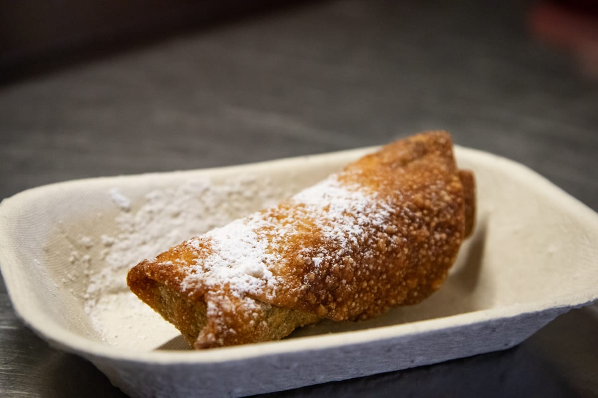 A deep fried Mars bar dusted with icing sugar